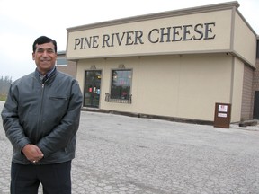 Former Pine River Cheese and Butter Cooperative general manager Vijay Kumar stands in front of the new Pine River Cheese store in December 2011.