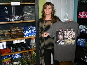 Colleen Stobbe shows off one of her favourite Duck Commander t-shirts, offered at her retail outlet, Shear Creations Gift Shoppe, just north of Port Rowan on Highway #59. Stobbe has found all things Duck Commander to be popular items, particularly during Port Rowan’s Festival By The Bay. Jeff Tribe/Tillsonburg News