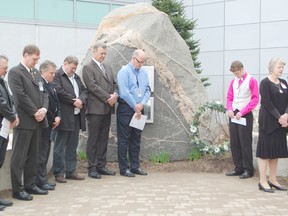 A moment of silence was observed at the annual Day of Mourning held at Bruce Power on April 29, 2013 in honour of workers who have been injured or died at their workplace across Canada. Speakers from the event laid a wreath and stood before the Memorial Cairn outside the site to remember those killed or injured at a workplace. L to R: Kevin MacKay, Bob Walker, Terry Doran, Tom MacLean, Dave Myette, Len Clewett, Presley Cormack and Diane Eaton. (ALANNA RICE/KINCARDINE NEWS)