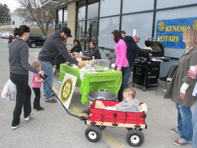 Doug Sweeney and Kristen Bailey with daughters Brook, 3, and Greer, 1, visit the hot dog stand hosted by Kenora Rotary volunteers in support of the Kenora Safeway fundraiser for Special Olympics, April 27.