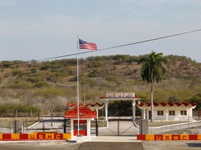 The Northeast gate marks the end of U.S. soil as the road leads into Cuba at Guantanamo Bay U.S. Naval Base, March 8, 2013.  Picture taken March 8, 2013. (REUTERS/Bob Strong)