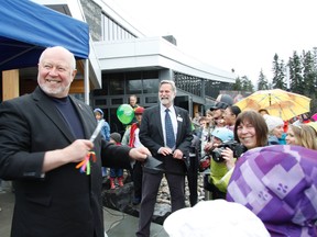 MLA and former Town of Canmore Mayor Ron Casey, left, along with current Mayor John Borrowman are all smiles after cutting the ribbon during the Grand Opening celebratons for Elevation Place on Saturday, April 27, 2013. Russ Ullyot/ Canmore Leader/ QMI Agency