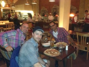 Frank Ferragine (left), Mark Domitric and Mohit Rajhans try out their pizzas at Disneyworld.