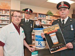 Brantford Chief of Police Jeff Kellner and Deputy Chief Geoff Nelson were at Dell Pharmacy on Tuesday with pharmacist Kevin Wojcik to promote “Prescription Drug Drop-Off Day” which will be held at the Wayne Gretzky Sports Centre on May 11. (BRIAN THOMPSON Brantford Expositor)