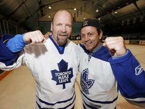 Former Maple Leafs Wendel Clark, left, and Doug Gilmour mug for the camera at St. Michael’s College School Arena in Toronto.