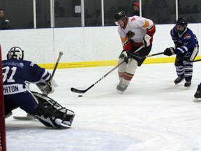 Paris Mounties defenceman Ned Simpson slips around a Woodstock Navy Vets defender to get a scoring chance in Game 4 of their first-round series Feb. 9, 2013. With the new division realignment and formal merger of the SOJHL and the NDJHL, the four Oxford County Jr. C teams weigh in on what it means for their teams. (GREG COLGAN, Sentinel-Review)