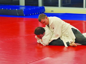 Portage la Prairie judokas Pinto Town, top, and Chysom Scott at Judo Club practice. (Kevin Hirschfield/THE GRAPHIC/QMI AGENCY)