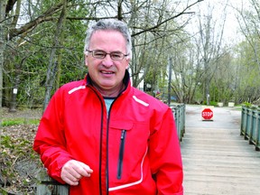 Dale Chisamore pauses on the foot bridge along the Brock Trail at Elm Street, where he hopes to lead locals in a Jane's Walk event Saturday that will encourage people to stop and contemplate their urban environment (RONALD ZAJAC/The Recorder and Times).