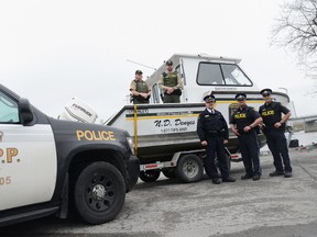 Ministry of Natural Resources officers Laurie Allin and Kyle Wood (on the boat) are shown here with Quinte West OPP detachment commander Insp. Mike Reynolds, marine officer Rob Donohoe and Const. Tony Gabrielli Tuesday morning in Trenton. The conservation and police officers will be patrolling the local waters this weekend.

Emily Mountney Trentonian