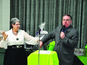 First Step Options executive director Greta Landry-Masseau, left, and Pembroke Pentecostal Tabernacle Pastor Terry Burns hold a door prize draw at the pregnancy support centre's first annual fundraising banquet, held in the hall at Our Lady of Lourdes Church in Pembroke.