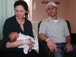 Shayne Duquette holds her day-old son Jack while dad Patrick looks on. Patrick is seated in one of the new sleeper chairs/cots being used in the maternal child care unit at Timmins and District Hospital. The chairs, which can be pulled out into a cot, are being used in a new program that encourages delivering moms at TDH to have the dad or a support person to stay with them overnight.