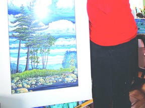 Christine Brandon and one of her large landscape pieces. She has many that showcase nature in Northern Ontario. 
Photo by Helen Morley/Mid-North Monitor/QMI Agency