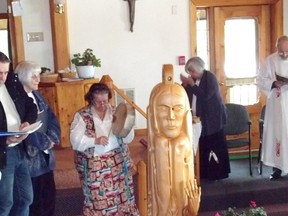 Diane Musgrove, of Birch Island, beats the ceremonial drum next to a statue of St. Kateri Tekakwitha. 
Photo by Patricia Drohan-Bordonaba, For the Mid-North Monitor