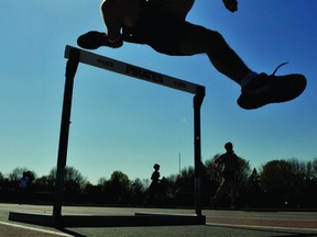 Thousand Islands Secondary School steeplechase competitor Garrett Rodley clears a hurdle under a bright, warm spring sun Wednesday afternoon as track and field athletes prepared for this week's Kinsmen-Hungerford Track and Field Classic. DARCY CHEEK The Recorder and Times