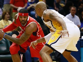 Atlanta Hawks forward Josh Smith (left) looks for an opening against Indiana Pacers forward David West during NBA playoff action in Indianapolis May 1, 2013.   (REUTERS/Brent Smith)