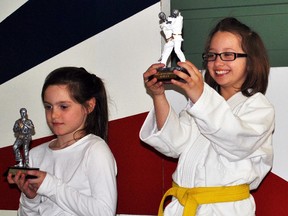 Quinte Judo Club's Michelle Currie (right) hoists her first place trophy at last weekend's Tora Judo Championships in Brampton.