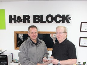 H & R Block in Melfort recently made a donation to the Melfort KidSport Committee. (L to R) Mike Rybinski of the Melfort KidSport Committee and Arthur Holmes of H & R Block.