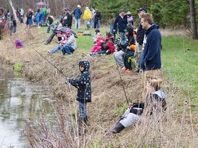 Families fish during the Warkworth Community Service Club 25th annual Children's Fishing Derby. The derby, held at Ryken's pond, allowed children 14 and under to catch and take home three fish. The derby was held Saturday and Sunday and is a fundraiser for the Warkworth Community Service Club.