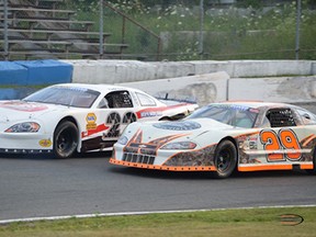 Todd Delisle and Bryan Sudsbury battle door-to-door in Vanguard Self Storage Late Model action during the 2012 season at Peterborough Speedway.