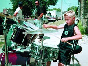 A busking Justin Bieber is shown performing on a sidewalk in Stratford, Ont., in this file photo from 2002. (STRATFORD BEACON HERALD)