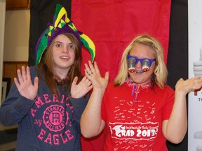 Skye McQuiggan (left) and Kayla Geoffrey (right) were just two of several Grade 8 students from Straffordville Public School helping out with the Home & Rec Show Saturday. Here, they took a few minutes to have a little fun in the party photo booth, one of 37 vendors at the show. For additional photos of the event, turn to Page 5. KRISTINE JEAN/TILLSONBURG NEWS/QMI AGENCY