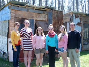 Staff at Pearce Williams Christian Centre stand with students in the Youth Challenge Program outside a shanty at World Camp at Pearce Williams Christian Centre. From left - Meagen Pyper of Pearce Williams Christian Centre, Sidney Robertson, Abby Ladouceur, Grace McColl, Caroline Voyer and Donovan Ladner, Pearce Williams Christian Centre.