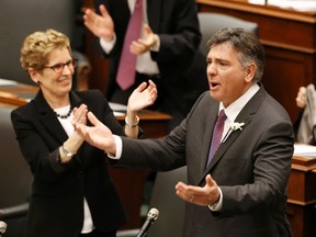 Ontario Finance Minister Charles Sousa (R) is applauded by Premier Kathleen Wynne before delivering the provinces budget in Toronto, May 2, 2013. (REUTERS)