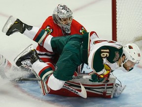 Minnesota Wild forward Jason Zucker crashes into Chicago Blackhawks goalie Corey Crawford during NHL playoff action in Chicago April 30, 2013. (REUTERS/Jim Young)