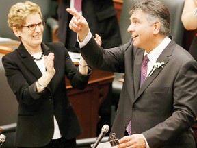 Ontario Finance Minister Charles Sousa (R) is applauded by Premier Kathleen Wynne before delivering the province's budget in Toronto on Thursday.
REUTERS/MARK BLINCH