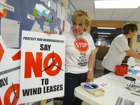 Marilyn Horner was volunteering selling anti-wind signs Thursday evening in the lobby of Lambton Centennial School before the start of an information meeting by the citizen's group Conservation of Rural Enniskillen. It formed earlier this year to oppose companies hoping to build wind farms in Enniskillen Township. (PAUL MORDEN, The Observer)