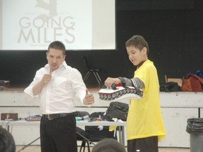 Aboriginal actor Dakota House demonstrates a martial arts move with the help of a youngster during his presentation at the event. - Brandi Morin, Reporter/Examiner