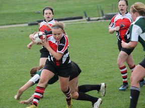 Liz Irvin of the girls junior Paris District High School Panthers rugby team dodges members of the St. John's Collegiate Green Eagles, a team the Paris group beat 19-17 at home on Monday. MICHAEL PEELING/The Paris Star/QMI Agency