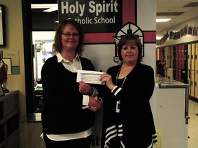 Tasha Desjardins (left) of the Devon Outgrown It Sale delivered donations from the Apr. 20 sale to Audrey McDonald, principal of Holy Spirit Catholic School on Monday, Apr. 29. The over $200 will be going towards the school’s computer lab.