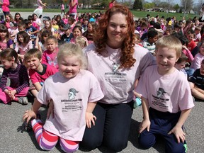 Melissa Hewitt, a member of the Lambton Kent District School Board Parent Involvement Committee, poses for a photo at Queen Elizabeth II School in Sarnia with her kids Shelby and Xander. The family is participating in Sunday's Kids Help Phone Walk in Sarnia, and were presented with a cheque for more than $300 Friday thanks to a joint fundraiser through Queen Elizabeth and Sir John Moore schools, through the "Knights Unite Against Bullying" campaign. (TARA JEFFREY/FOR THE OBSERVER/QMI AGENCY)