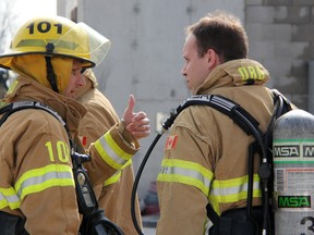 Observer reporter Tyler Kula gets some last-minute advice before heading into a fire and rescue simulation at Lambton College’s on-site Fire & Public Safety Centre of Excellence, recently. Kula spent the day training with members of the Sarnia Fire and Rescue Service. (TARA JEFFREY/THE OBSERVER/QMI AGENCY)