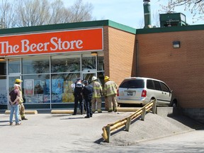 Emergency official deal with the scene of a crash and natural gas leak at the Paris Beer Store on Friday afternoon. MICHAEL PEELING/The Paris Star