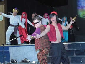 Aladdin, right, is played by Eric Venzon. The genie, centre, is played by Chandler Christie.