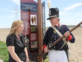 Dave Welton, member of the Battle of the Thames 2013 organizing committee, shares a laugh with Kyra Knapp, War of 1812 project facilitator for Southwest Ontario, during a stop along the Tecumseh Parkway, which was officially launched on Friday. The event included a bus trip that began in Jeannette's Creek and ended in Thamesville. (TREVOR TERFLOTH, Chatham Daily News)