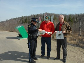 Const. Monique Baker (left), Jerry Demers, of Canadian Carver, and Lance Knox, of Ministry of Transportation, kicked off the 10th year of Stash Your Trash on Friday, May 4, 2013.