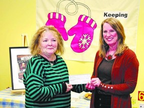 Donna Atkinson-Wilson, left, the founder of Keeping, receives a cheque for $20,000 from Shari Fulmer, a London realtor and head organizer of this year?s Mitten Ball. (Supplied photo)