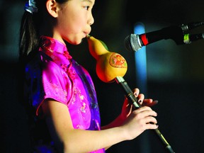 Anny Li, 10, plays a traditional Chinese hulusi prior to the official opening of the Brockville Multicultural Festival on Friday. The festival continues today at the Memorial Centre. (DARCY CHEEK/The Recorder and Times)