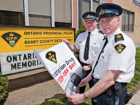 County of Brant O.P.P. Insp. Dave Durant (left) and Staff Sgt. Bev Prevett hold a banner denoting a prescription drug drop-off day on Saturday, May 11, between 10 a.m. and 3 p.m. at the detachment, located at 28 Mechanic Street in downtown Paris, Ontario. (BRIAN THOMPSON Brantford Expositor)