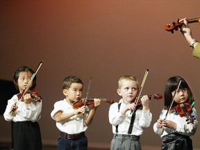 Three-year-old violin students look to their teacher: The Suzuki method of teaching violin is "revolutionary" because it goes back to the basics, writes columnist Murray Charters. (QMI FILE PHOTO)