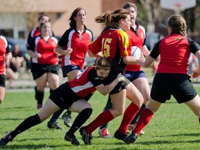 Thrashers player Jazmine Graham tries to tackle Maggie Kerr of the Sydenham Golden Eagles junior team during a Kingston Area Secondary Schools Athletic Association girls rugby game at Loyalist Collegiate on Friday. The Thrashers, comprised of players from Queen Elizabeth, Loyalist and Bayridge, won the game 20-17. (Julia McKay/For The Whig-Standard)