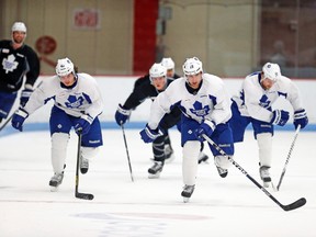Joffrey Lupul (19) skates between Tyler Bozak (left) and Phil Kessel, and just ahead of defenceman Jake Gardiner, during Friday’s Maple Leafs workout at Brown Arena at Boston University. Lupul practised on a line with both Bozak and Kessel, but could wind up playing Game 2 against the Bruins tonight with Nazem Kadri. (Michael Peake, Toronto Sun)