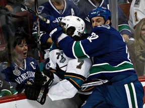 Vancouver Canucks forward Dale Weiss knocks San Jose Sharks defenceman Brad Stuart into the boards during Game 2 of their NHL Western Conference playoff series in Vancouver,  May 3, 2013. (REUTERS/Andy Clark)