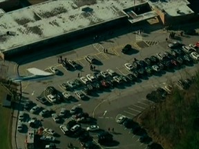 Police and emergency personnel set up in the parking lot after the shooting at Sandy Hook Elementary School in Newtown, Connecticut, December 14, 2012.  REUTERS/WNBC/Handout