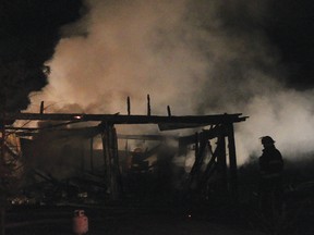 Laurentian Valley Township firefighters work to extinguish a garage fire located on a property at 656 Sandy Beach Road Thursday night. A total of 14 firefighters worked the fire until mopping it up shortly after midnight. For more community photos, please visit our website photo gallery at www.thedailyobserver.ca.