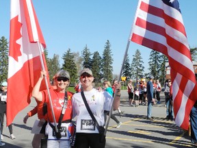 Joy Evans and Karyn Evans of Brantford held the Canadian and American flags before the Boston Marathon Memorial Run in Boston, Ont. on May 4. SARAH DOKTOR Simcoe Reformer