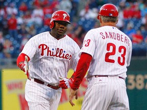 Ryan Howard of the Philadelphia Phillies is congratulated by third base coach Ryne Sandberg after hitting a home run against the Miami Marlins during the second inning in a MLB baseball game on May 3, 2013 at Citizens Bank Park in Philadelphia, Pennsylvania. (AFP)